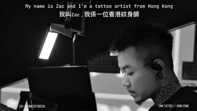 Calm side-profile of focused tattoo artist at work