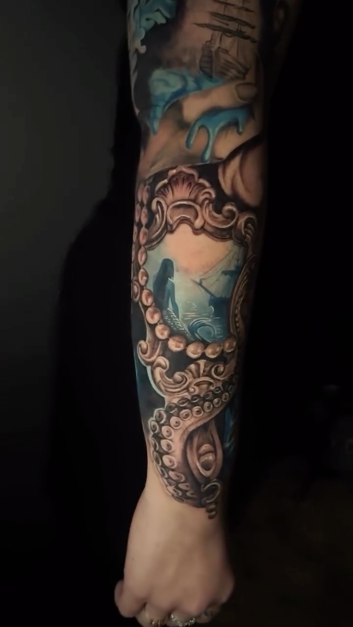 Siren mermaid framed by ornate tentacles, ocean blues