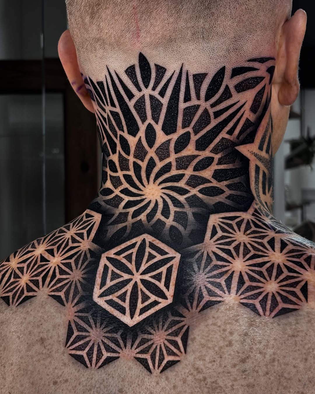 Intricate geometric mandala neckpiece with starburst tessellations