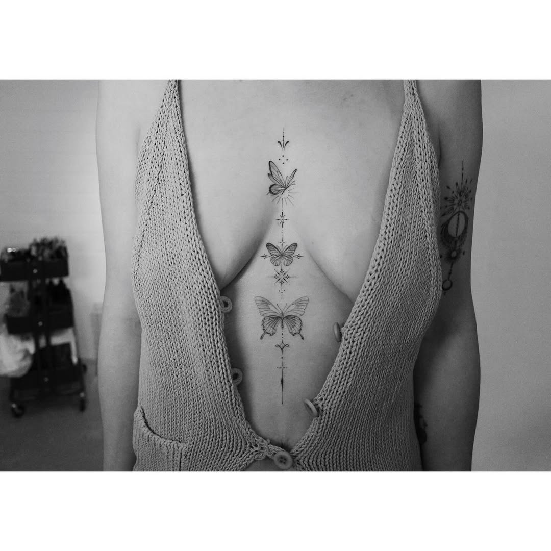 Delicate fineline butterfly column along spine with geometric accents