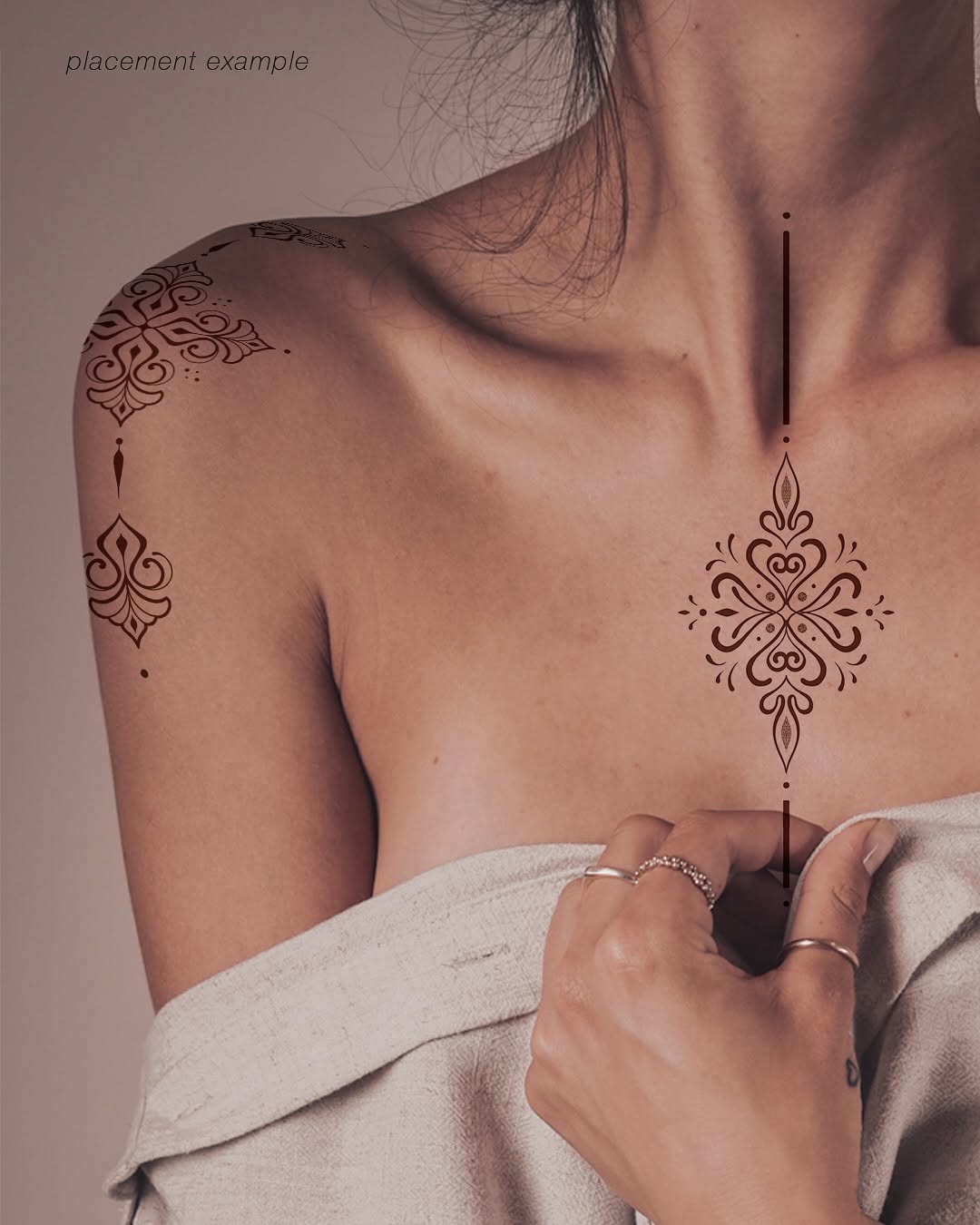 Intricate brown filigree chest and shoulder tattoo.