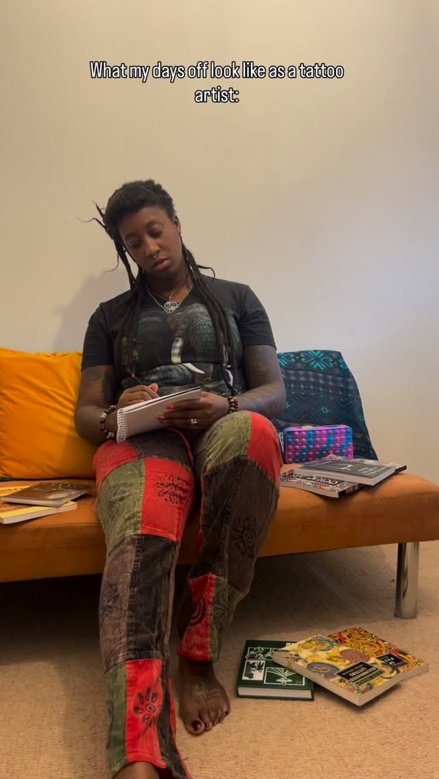 Casual portrait of a tattooed artist sketching.