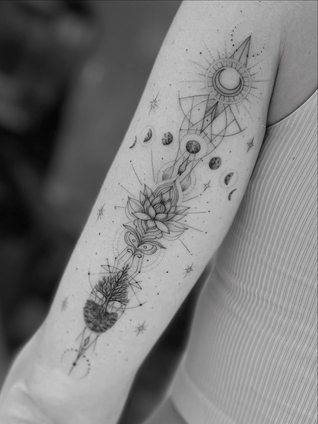 Intricate geometric lotus with lunar phases and celestial accents.