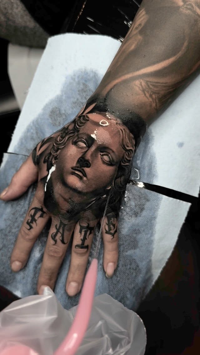 Classical bust portrait on hand in black-and-gray realism