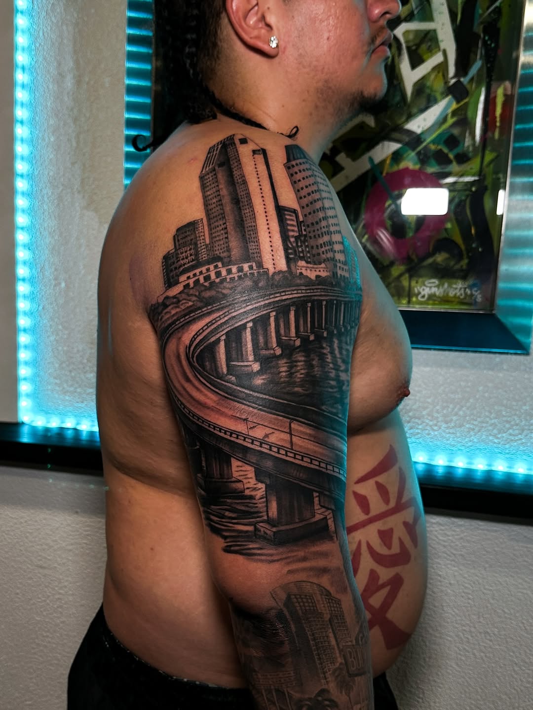 Dramatic black-and-gray cityscape with sweeping bridge arc