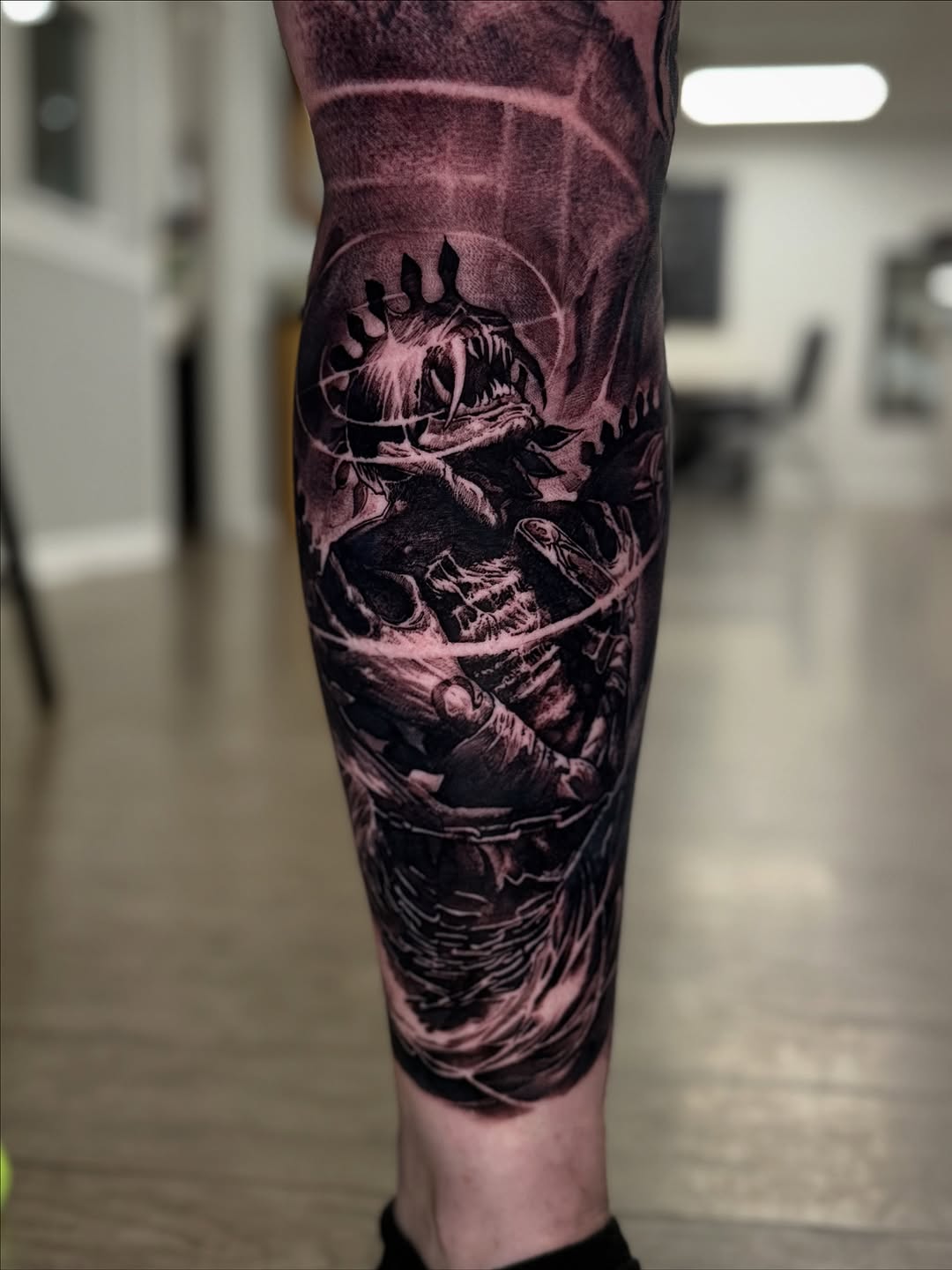 Grayscale Final Fantasy creature battle scene on leg