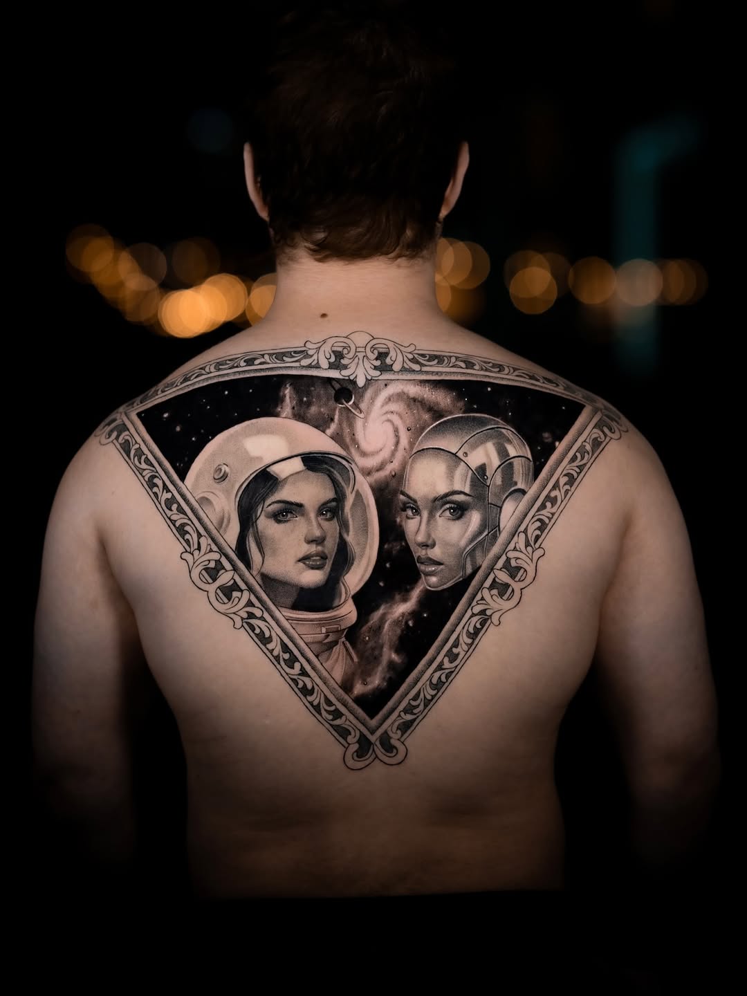 Ornate triangular back piece with twin astronaut portraits