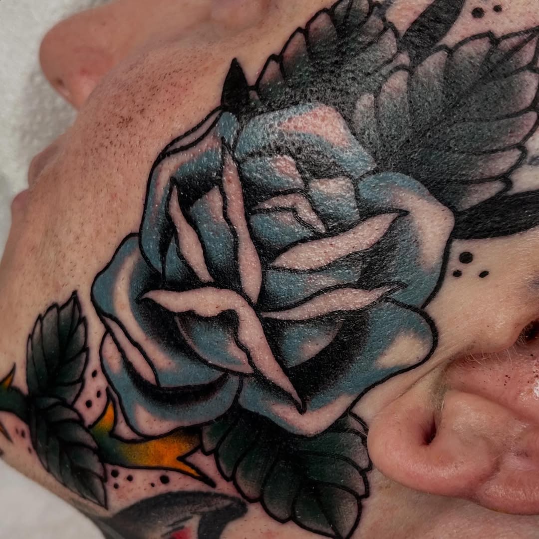 Colorful rose face tattoo