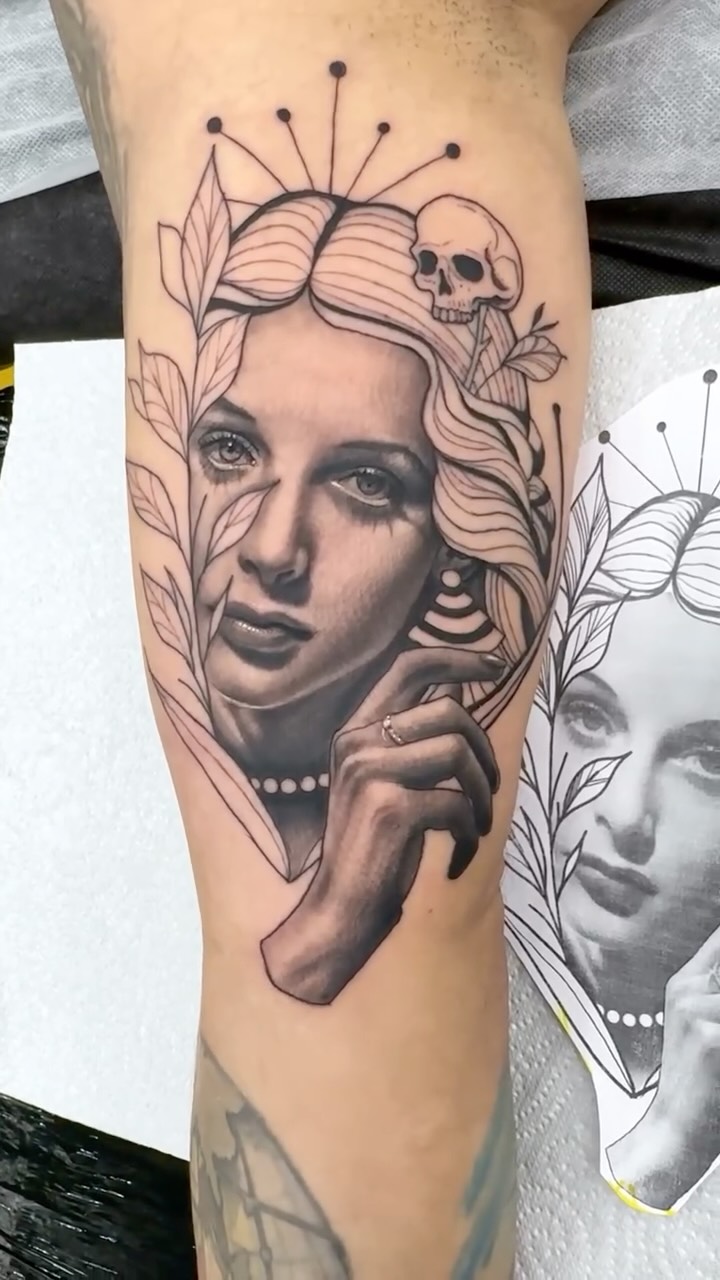 Grayscale portrait with botanical halo and skull