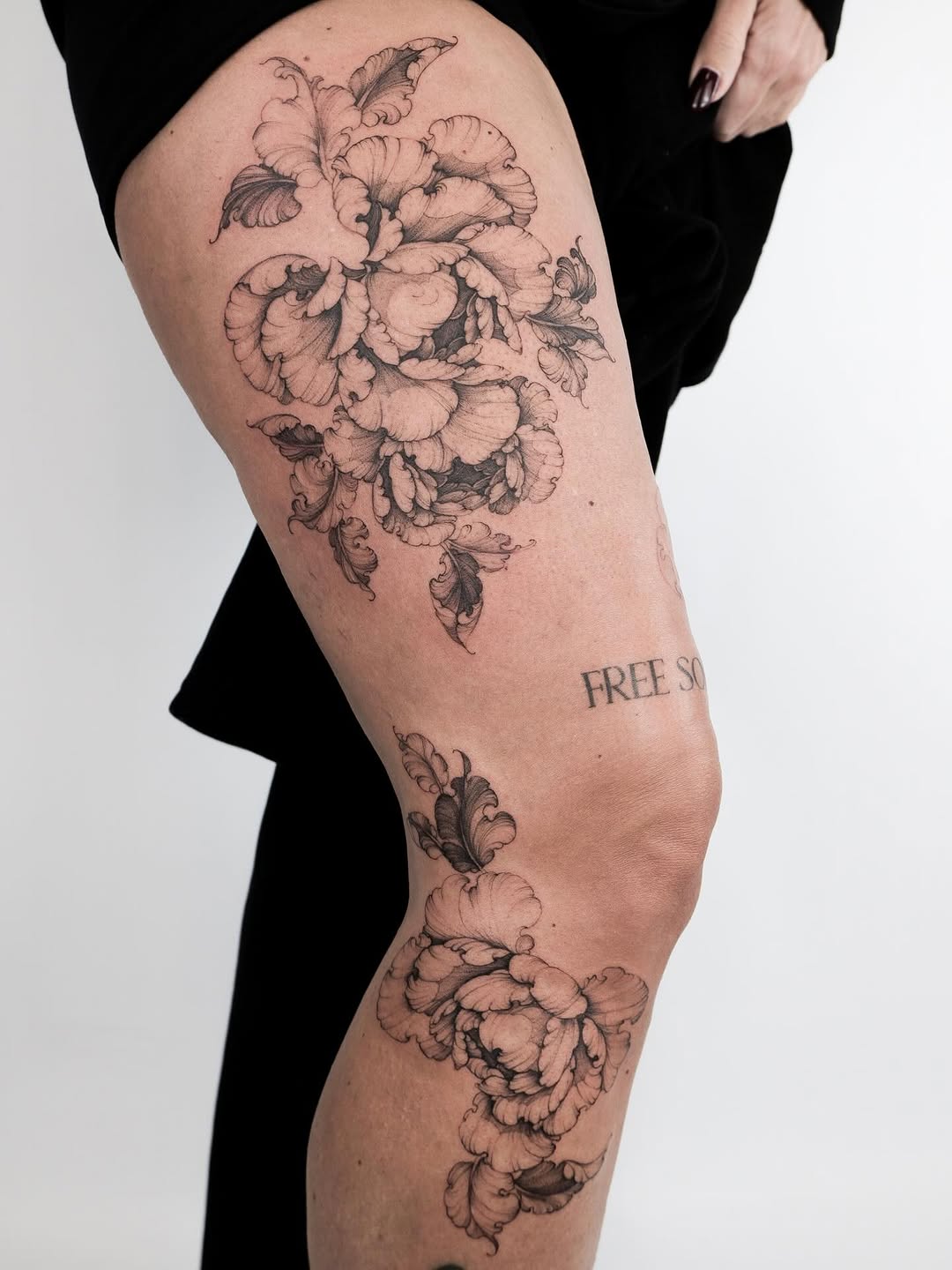 Intricate black-and-gray floral leg-sleeve with flowing petals