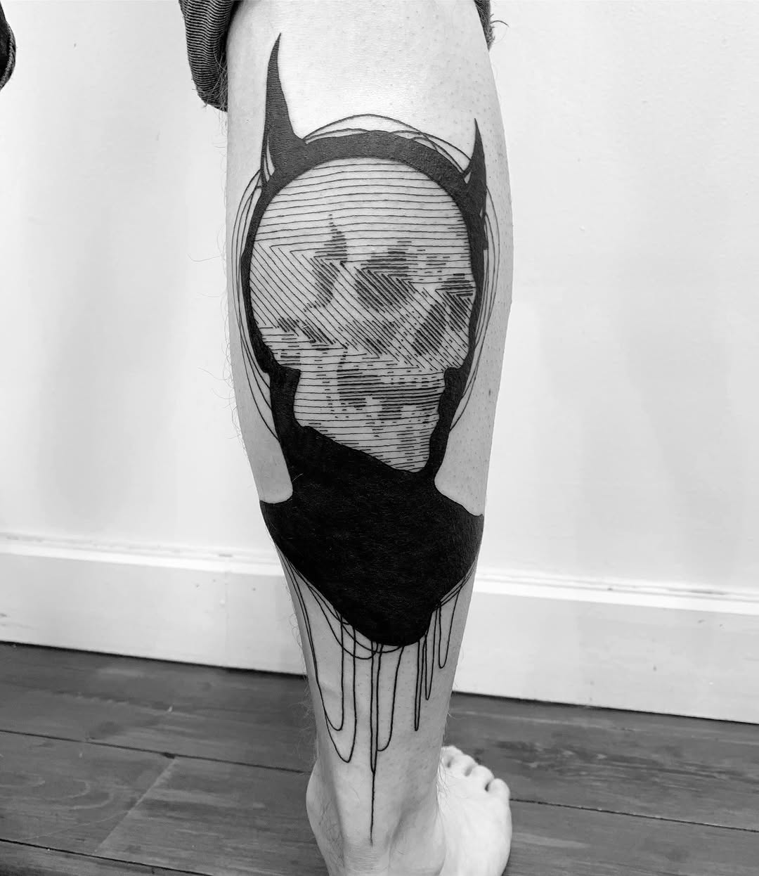 Bold blackwork skull inside circular frame with dripping ink