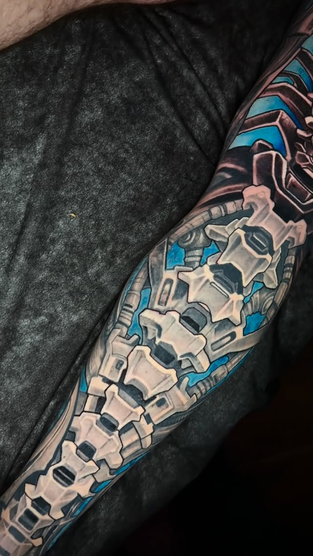 Sleek biomechanical calf sleeve with chrome segments and cobalt highlights