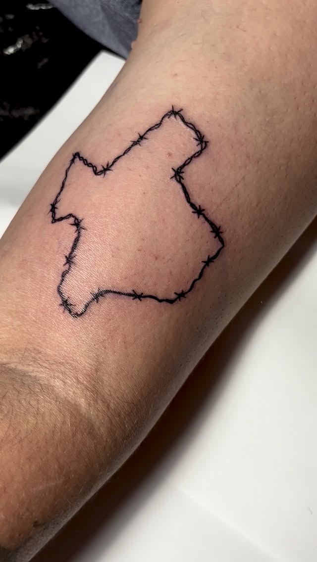 Minimalist Texas silhouette framed by barbed-wire border.