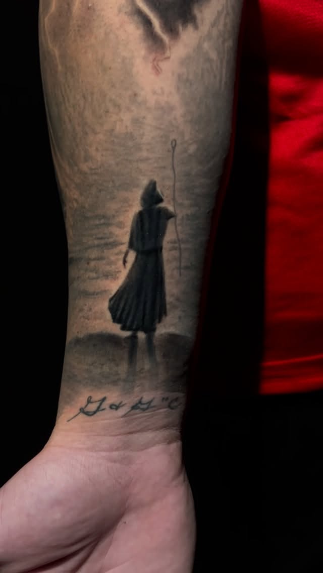 Misty biblical Moses with staff in grayscale landscape