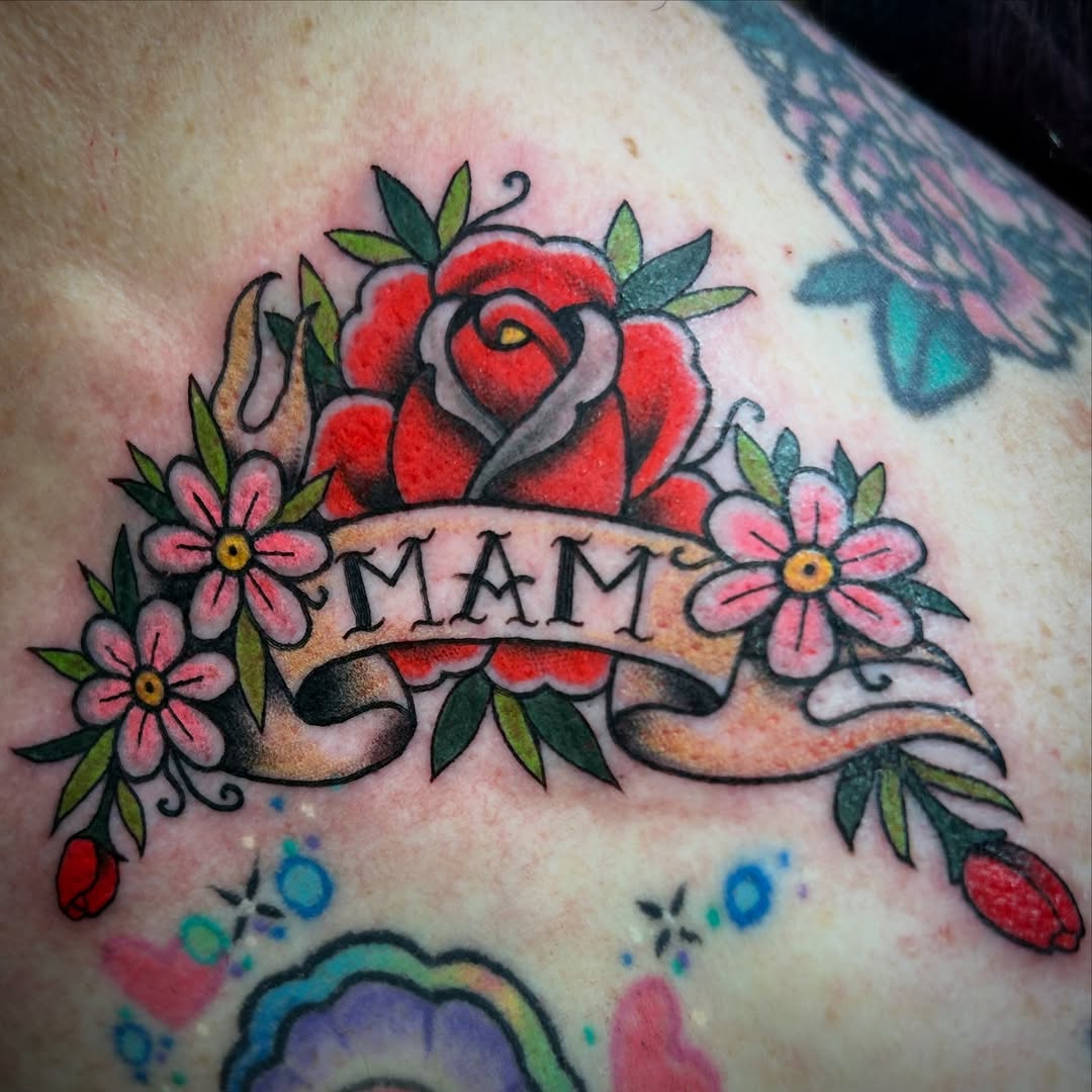 Bold traditional rose with ribbon banner and blossoms