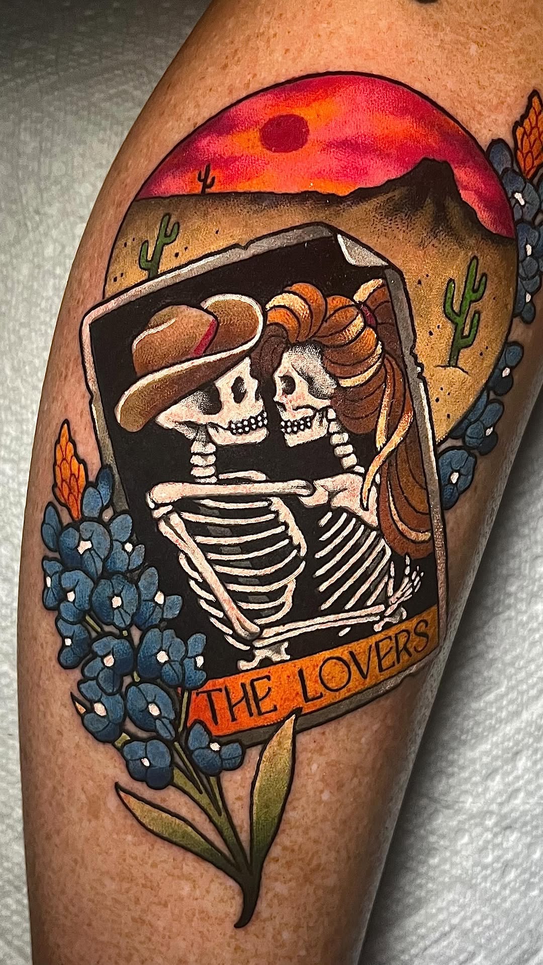 Bold neo-traditional tarot lovers skeletons in desert