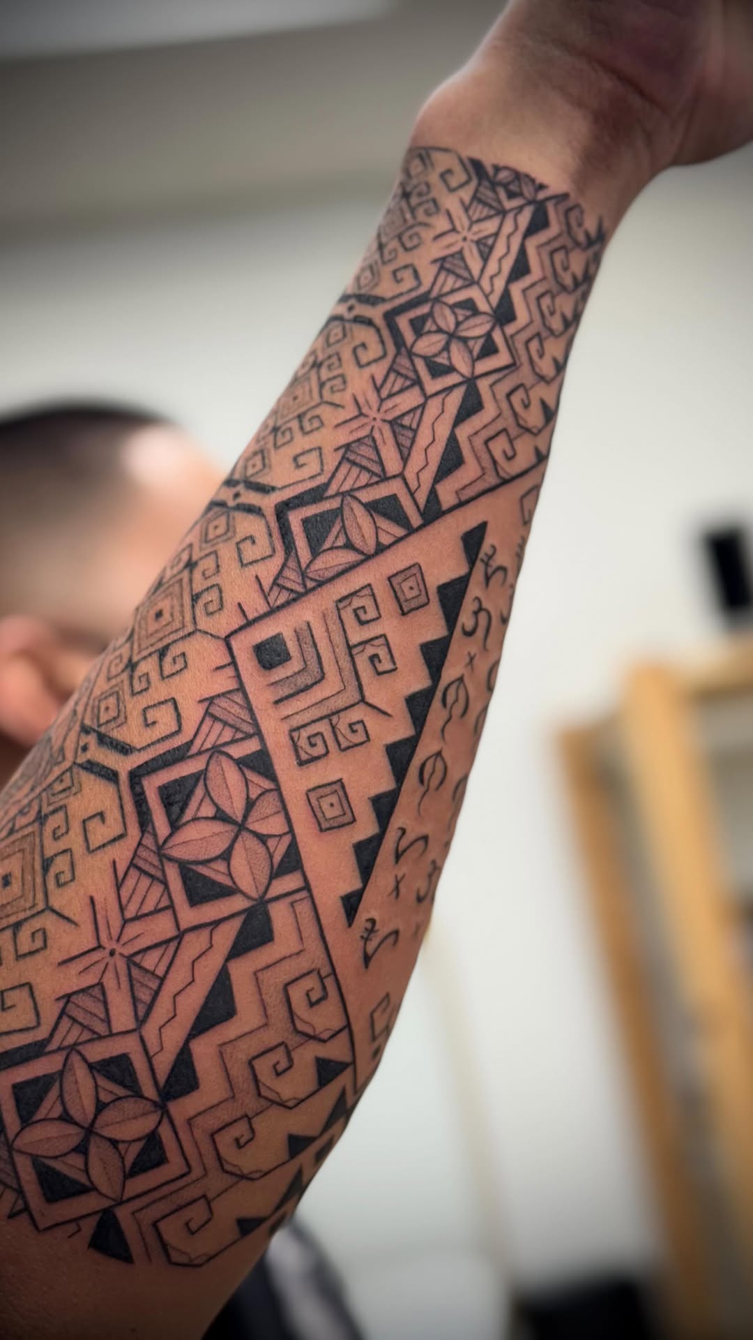 Blackwork geometric Polynesian-inspired forearm sleeve with spirals