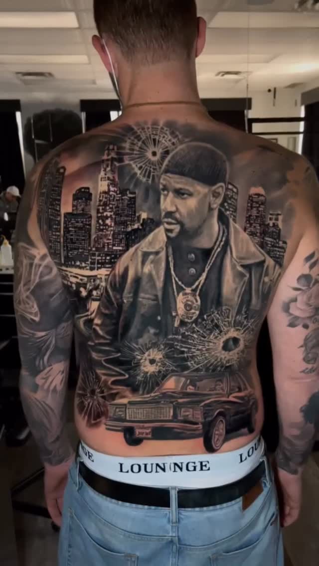 Monochrome back-piece portrait with cityscape and vintage car.