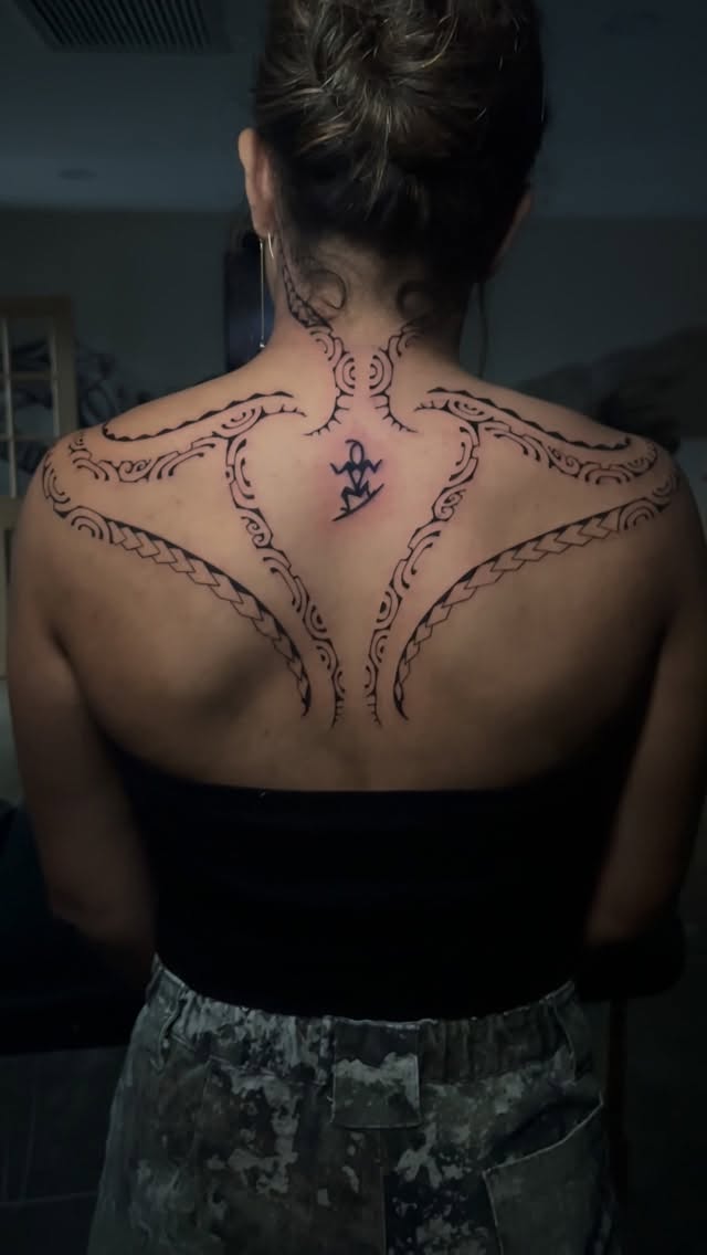 Ornamental Polynesian-inspired back piece with flowing lines