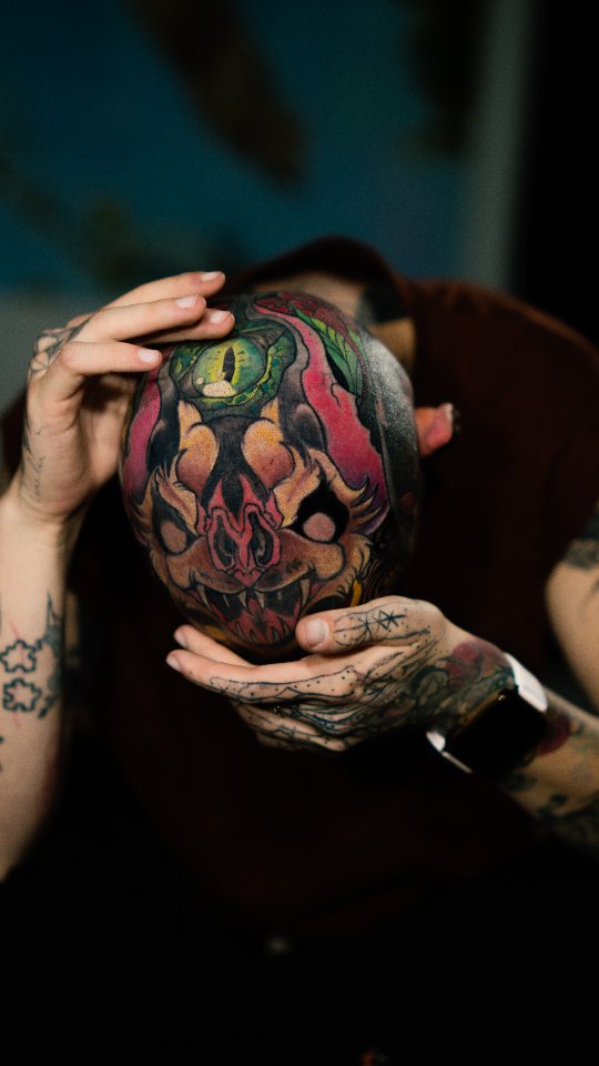 Vibrant demon-skull head tattoo with bold colorwork