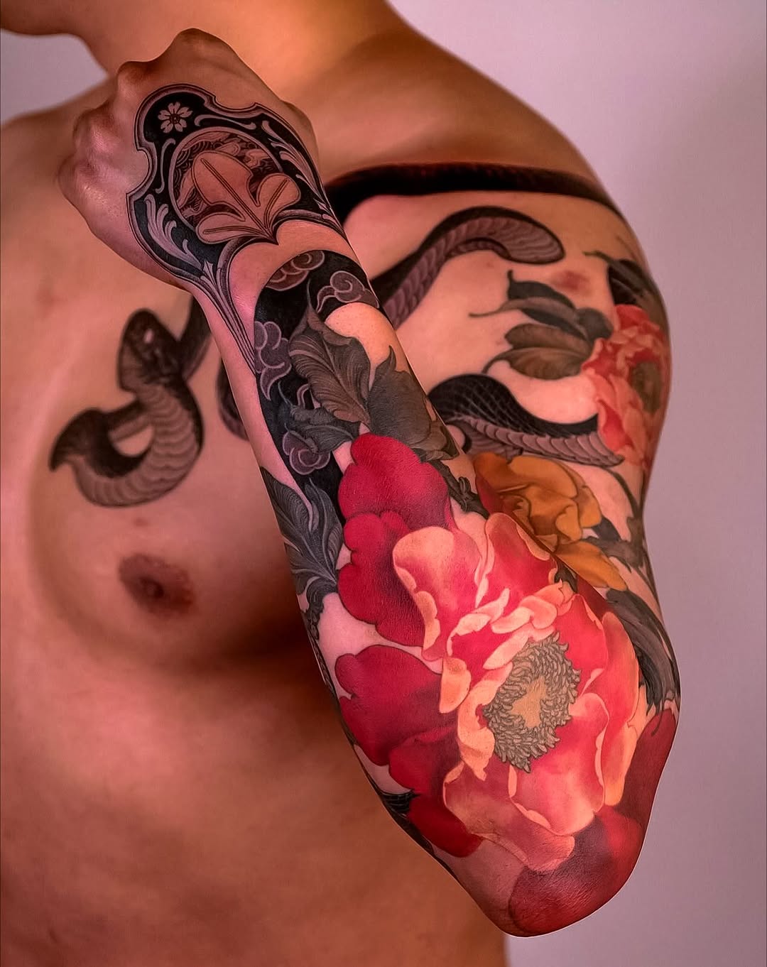 Vibrant Japanese snake entwined with bold peony blossoms