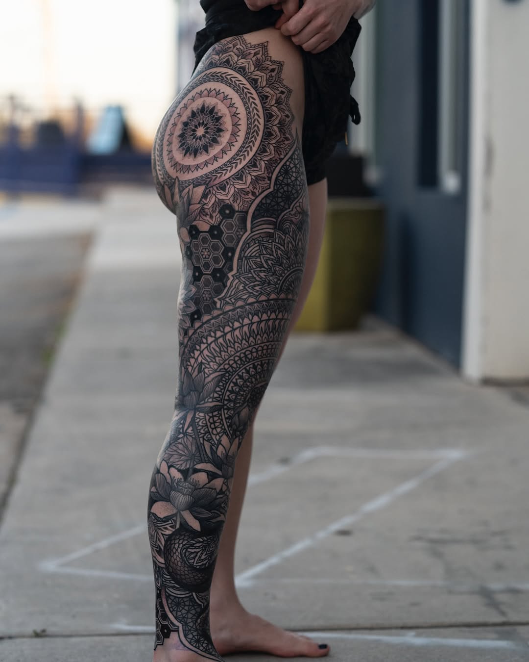 Elaborate blackwork leg sleeve with mandala and floral motifs