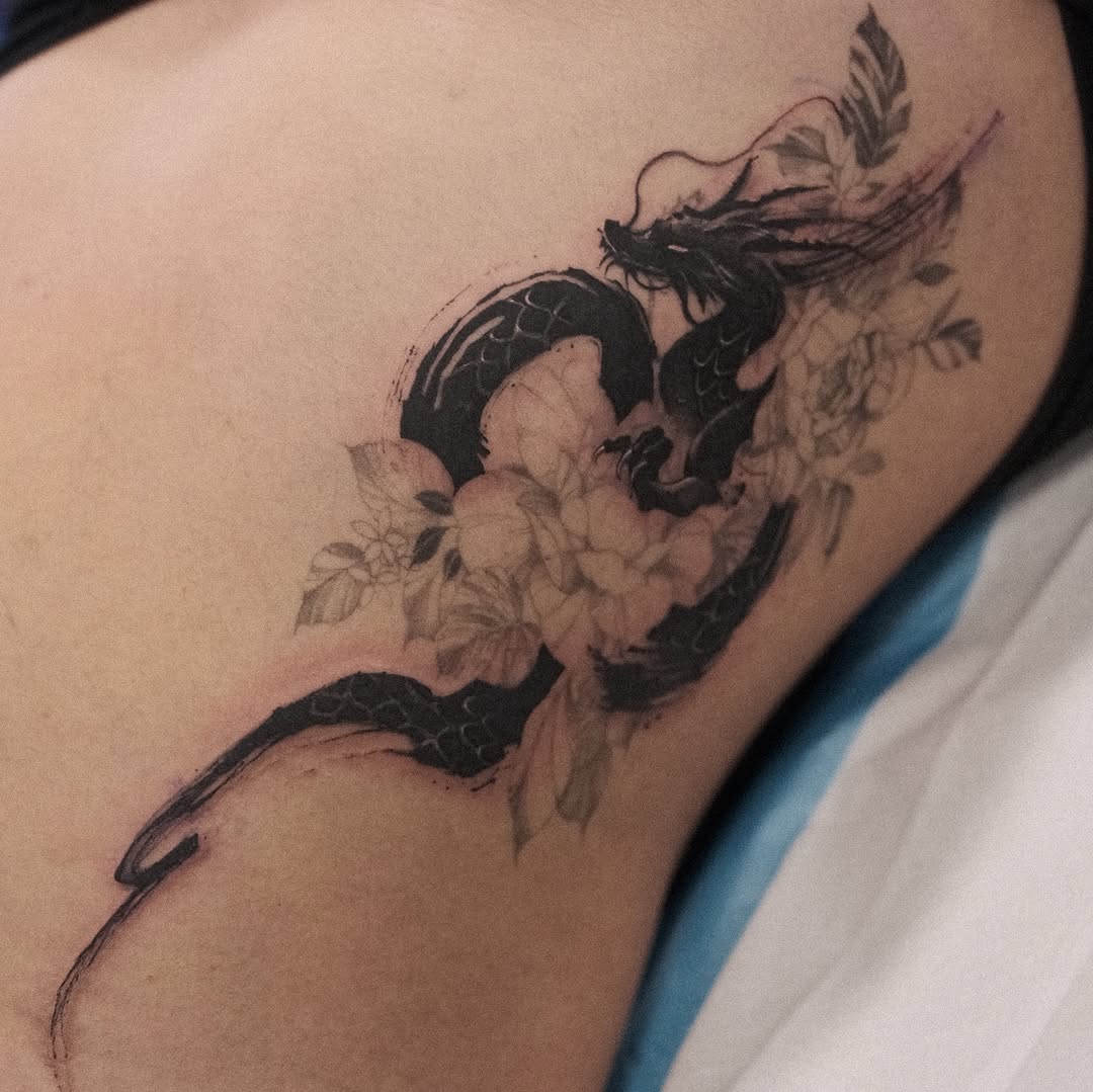 Bold black dragon entwined with delicate floral linework.