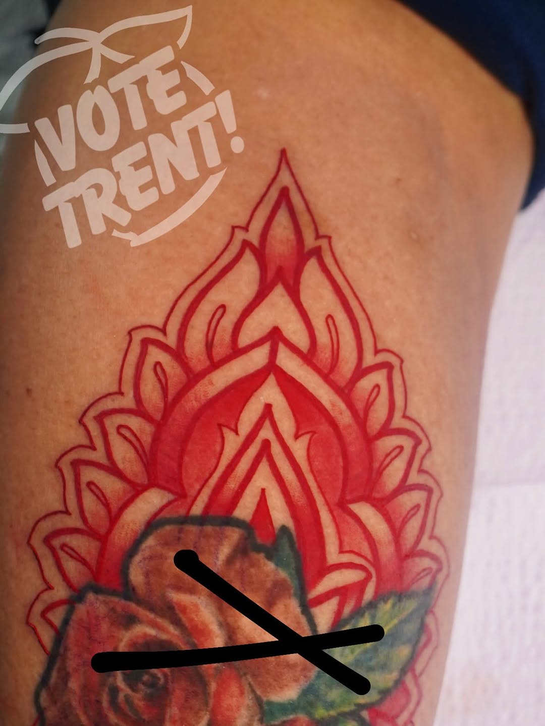 Vibrant red ornamental mandala flame on upper arm