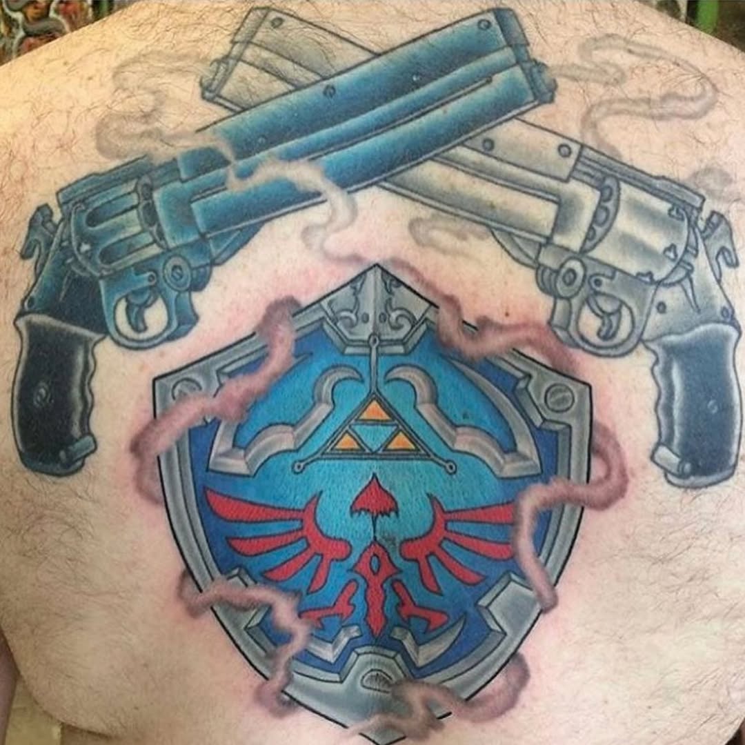 Vibrant Hyrule shield with red Triforce, framed by pistols