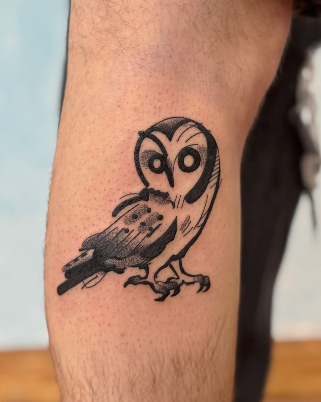Playful barn owl in bold-line blackwork with dot shading.