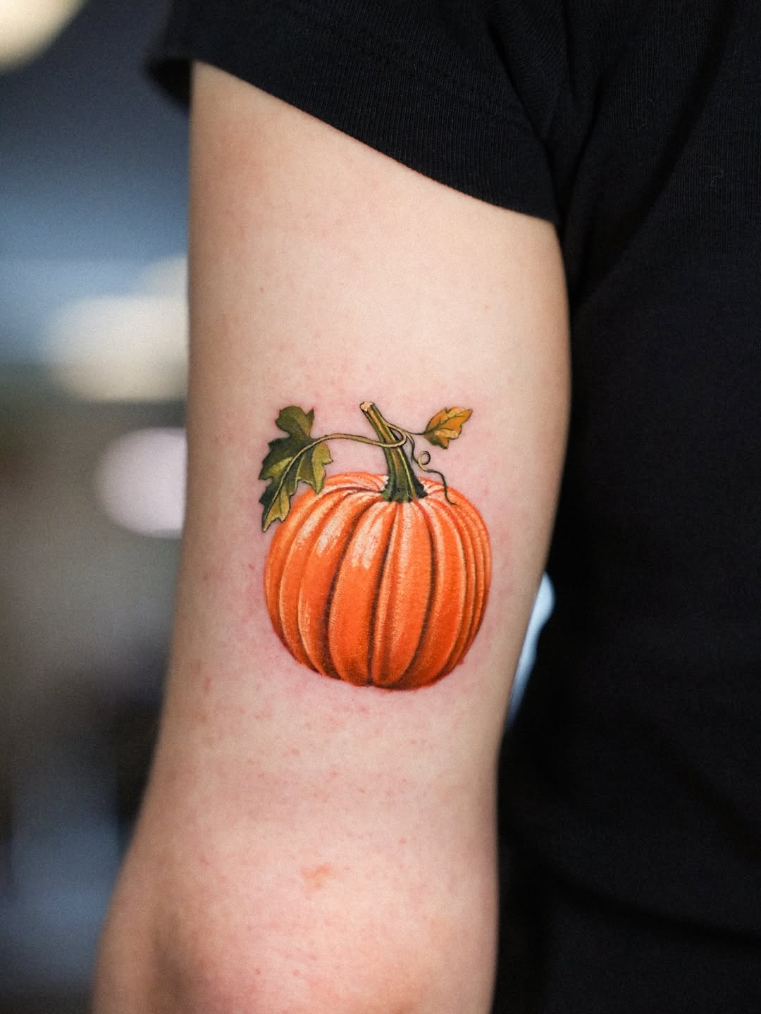 Vivid orange pumpkin with glossy shading and leaves.