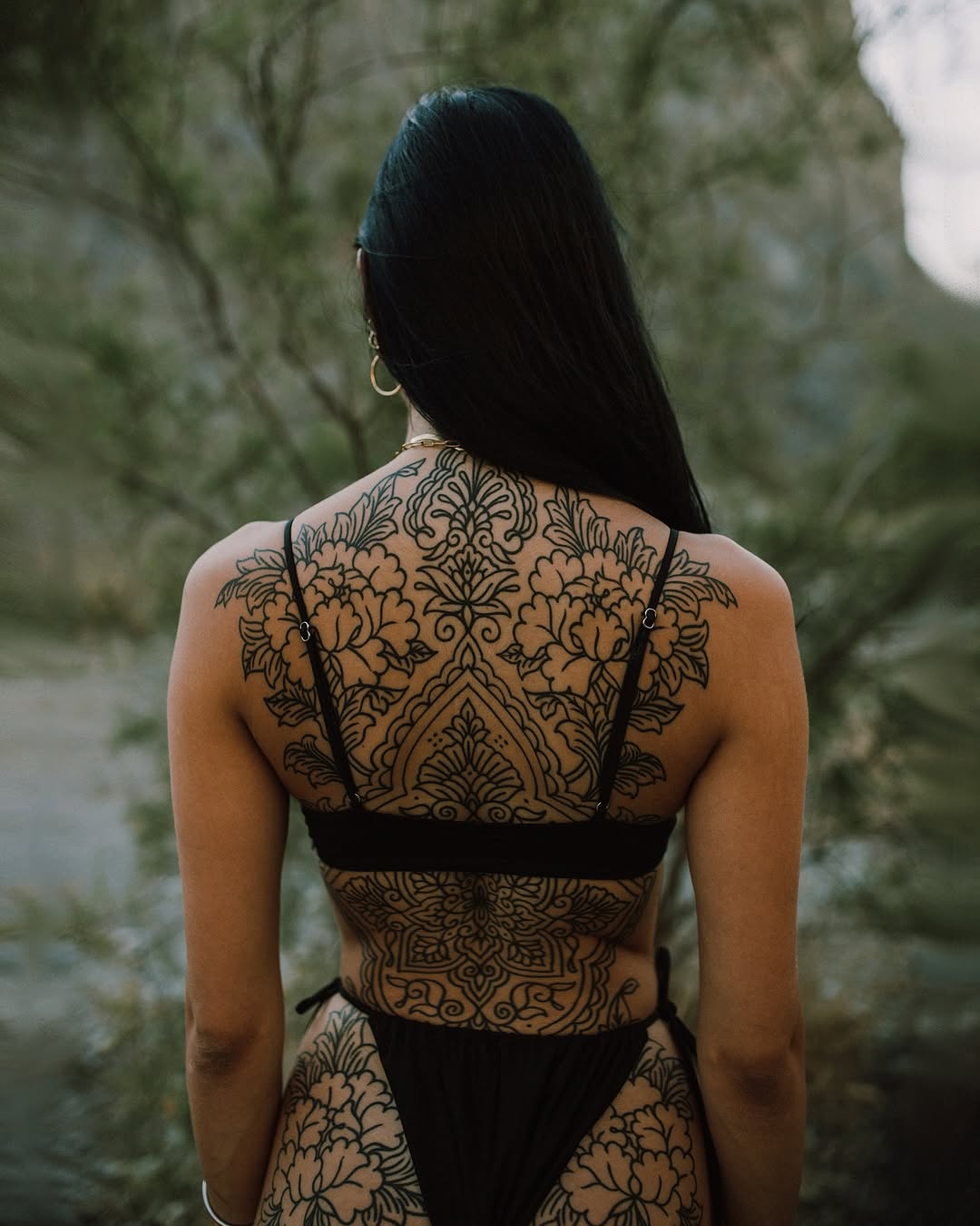 Intricate blackwork floral ornamental backpiece with symmetry