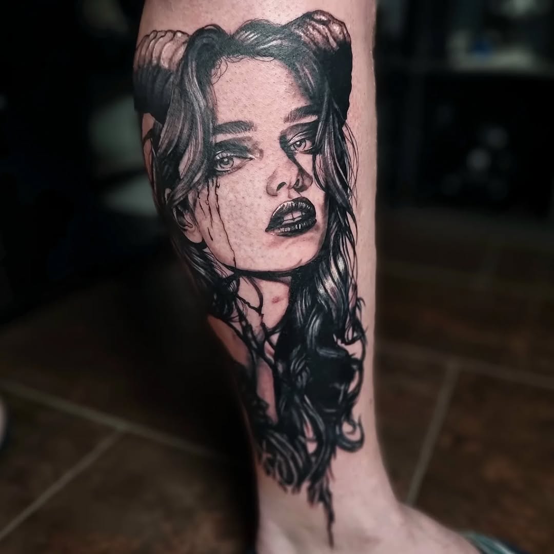 Gothic demon-girl portrait in bold blackwork on leg