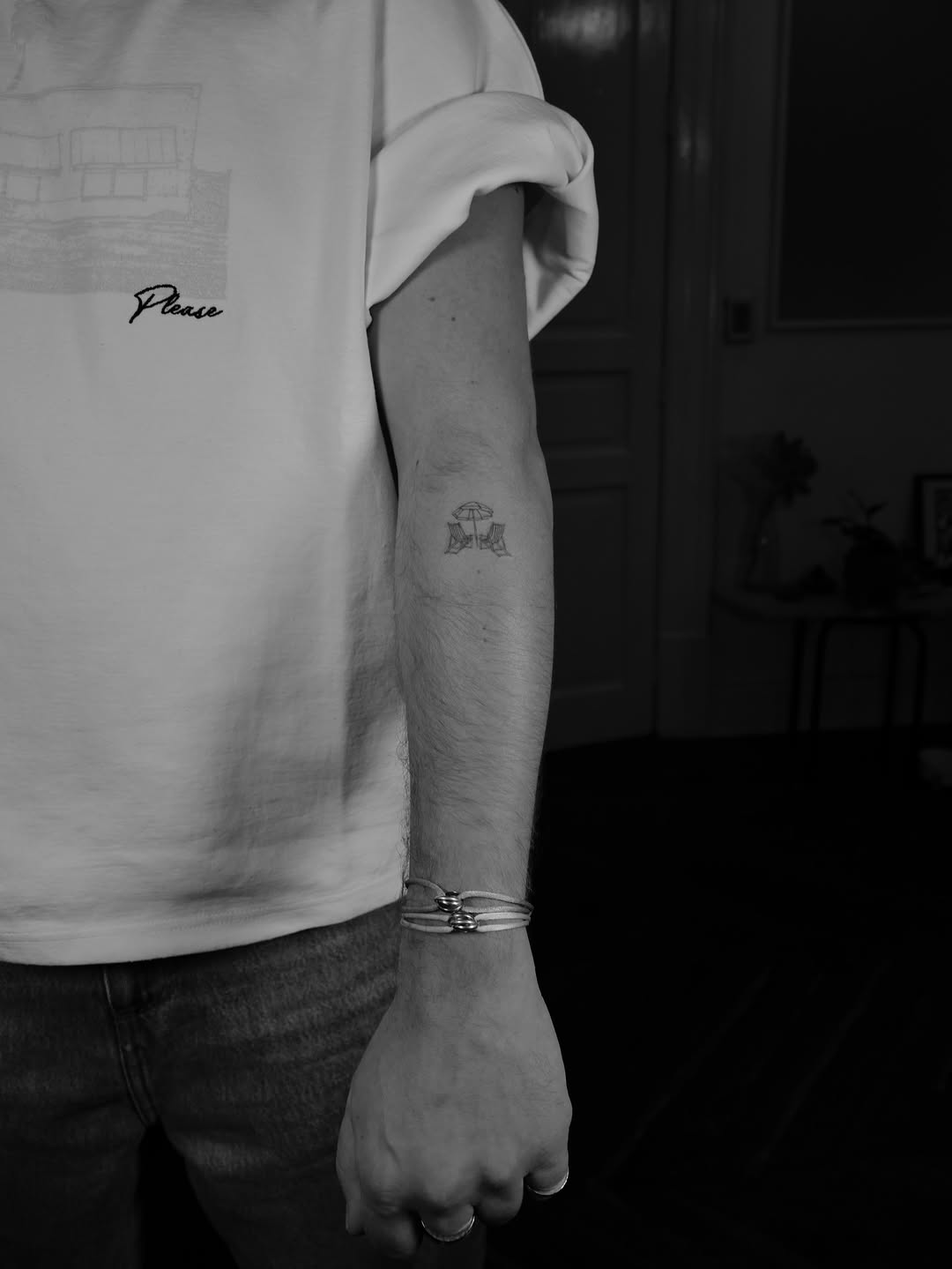 Tiny fine-line umbrella motif with two chairs