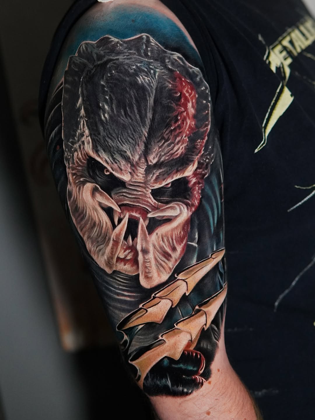 Hyper-detailed Predator portrait on upper arm, photorealistic.