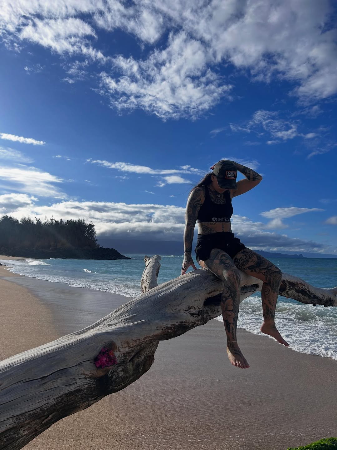 Dense blackwork tattoos covering arms and legs, highly contrasted.