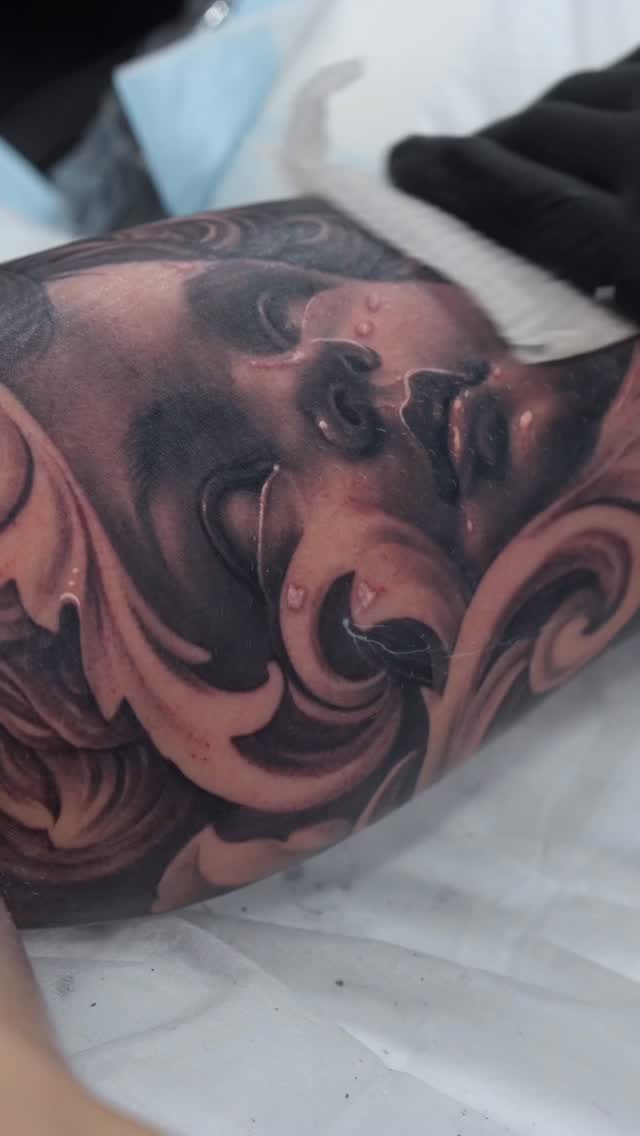 Intricate black-and-gray realism with swirling ornamental panels