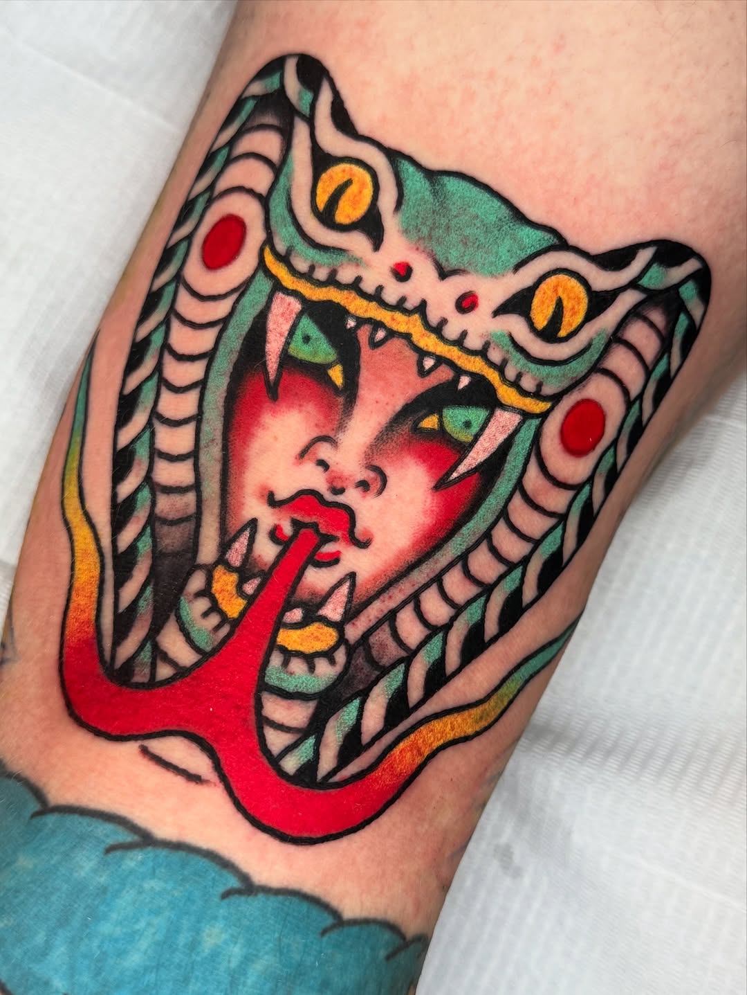 Bold neo-traditional cobra hood with a feminine face