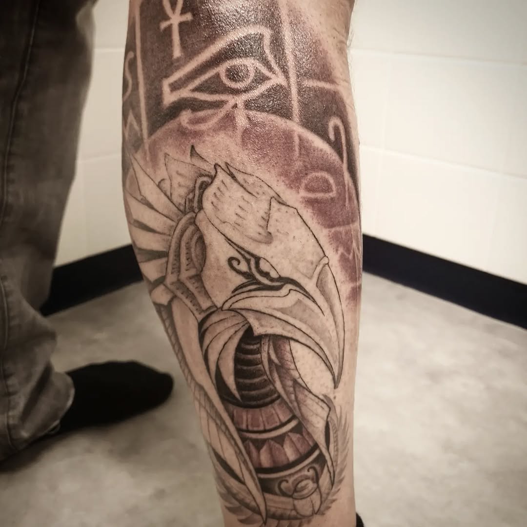 Bold blackwork Horus falcon with Eye of Horus and Ankh on calf