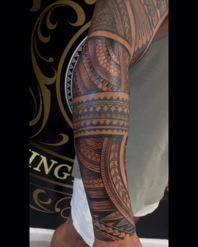 Bold Polynesian-inspired forearm tribal sleeve with geometric bands.