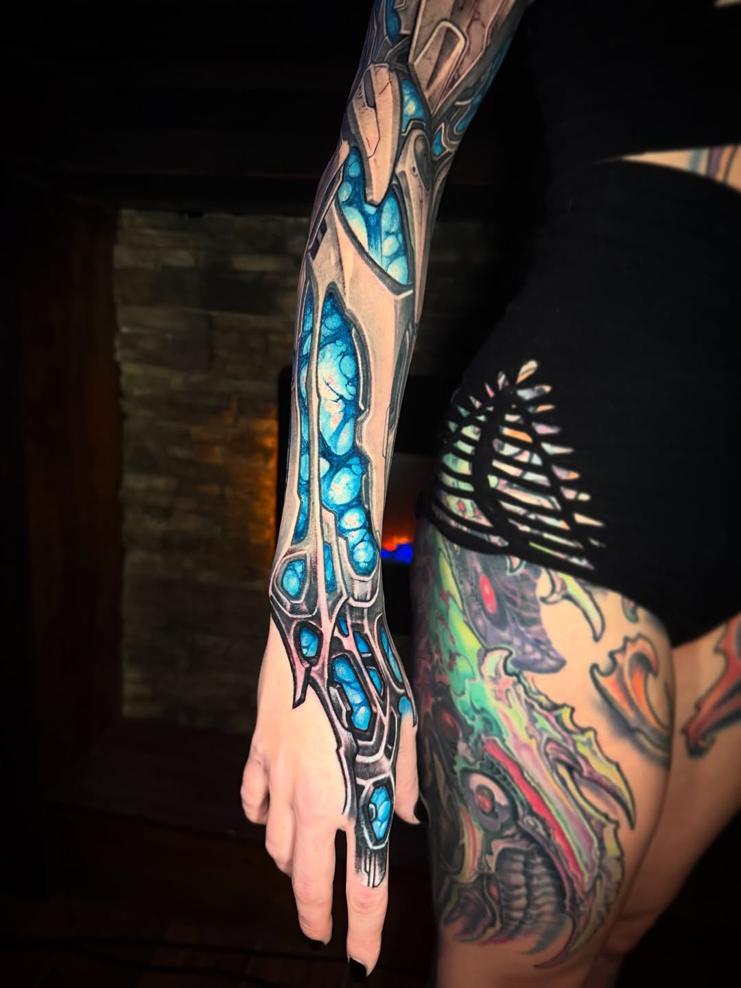 Futuristic biomechanical sleeve with cobalt blue crystal inlays