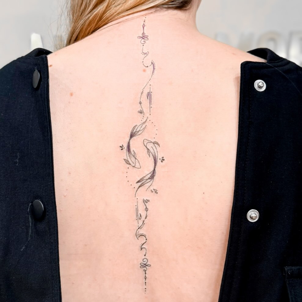 Delicate spine-length koi fish linework with dot accents