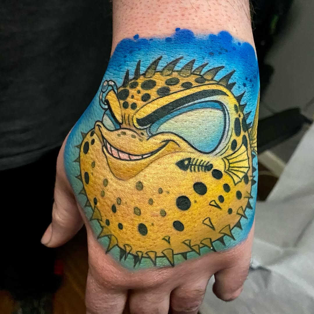 Whimsical yellow pufferfish with bold black spots, cartoony.