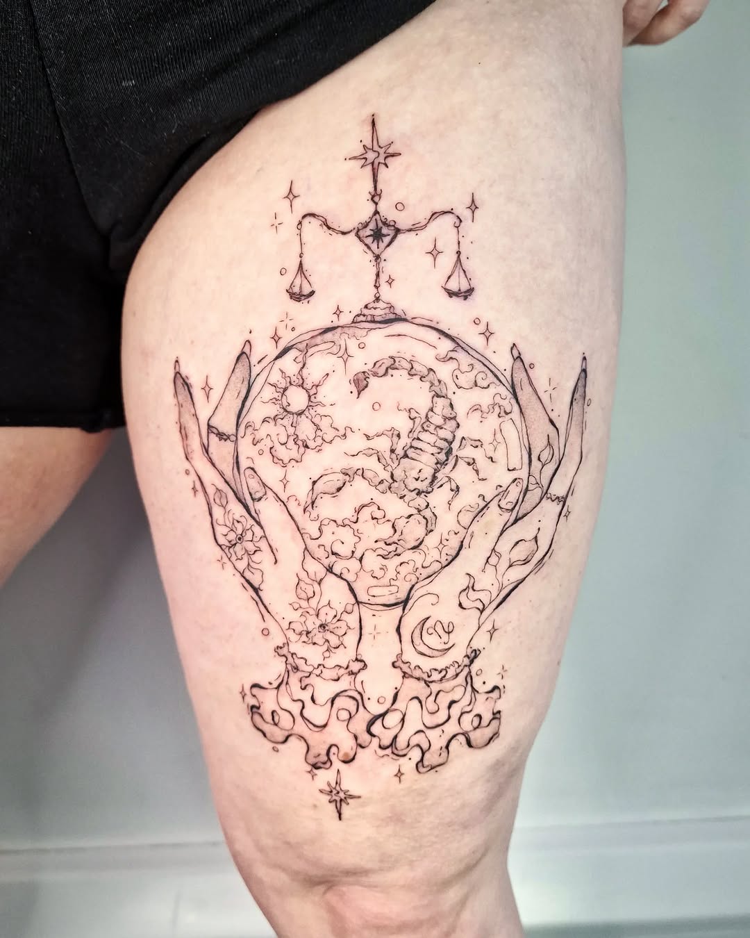 Intricate hands cradle a celestial crystal ball beneath Libra scales.