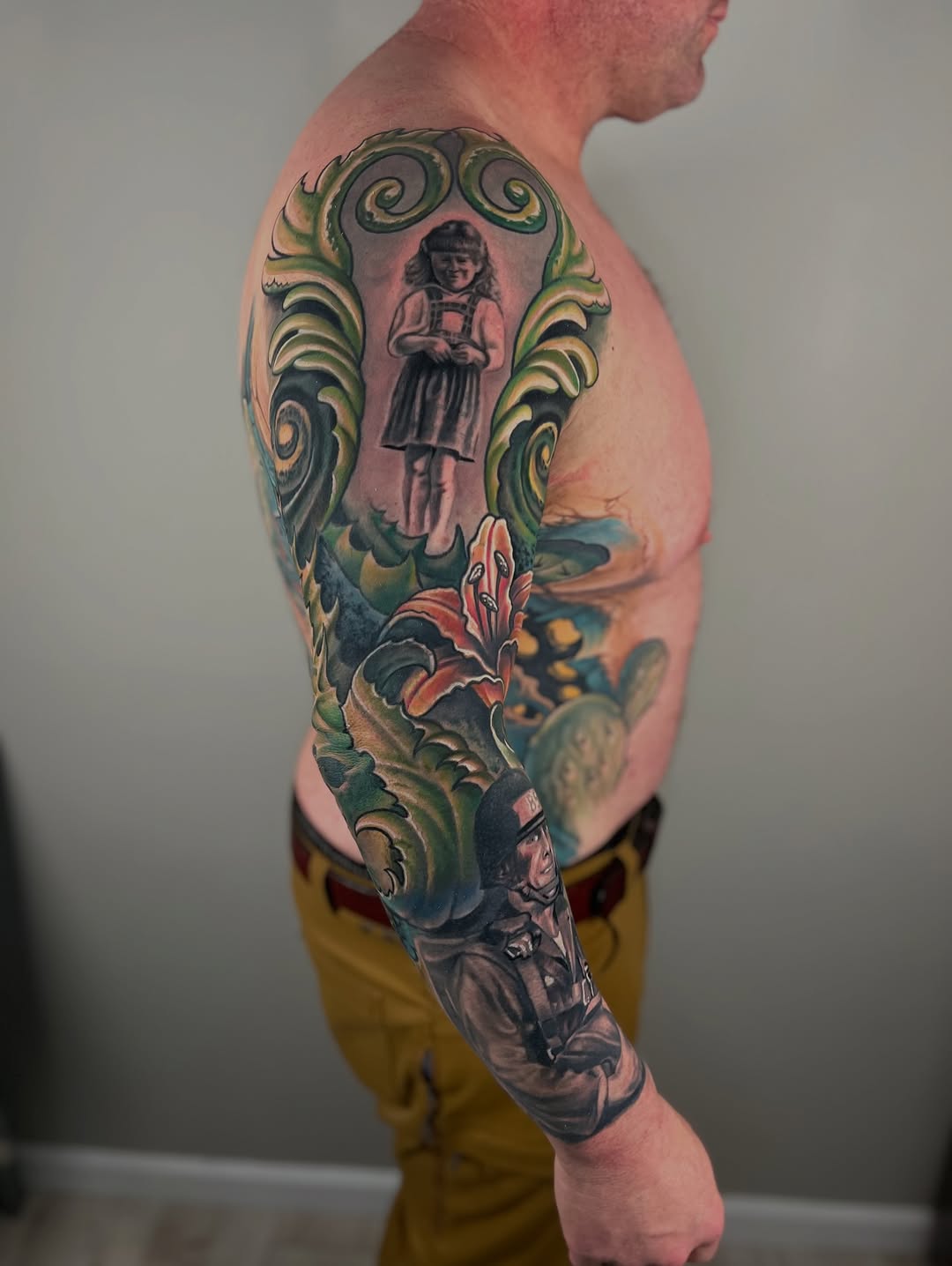 Vibrant neo-traditional sleeve with swirling green motifs around a girl portrait