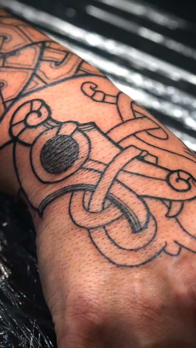 Bold Nordic serpent knotwork wrapping the forearm.