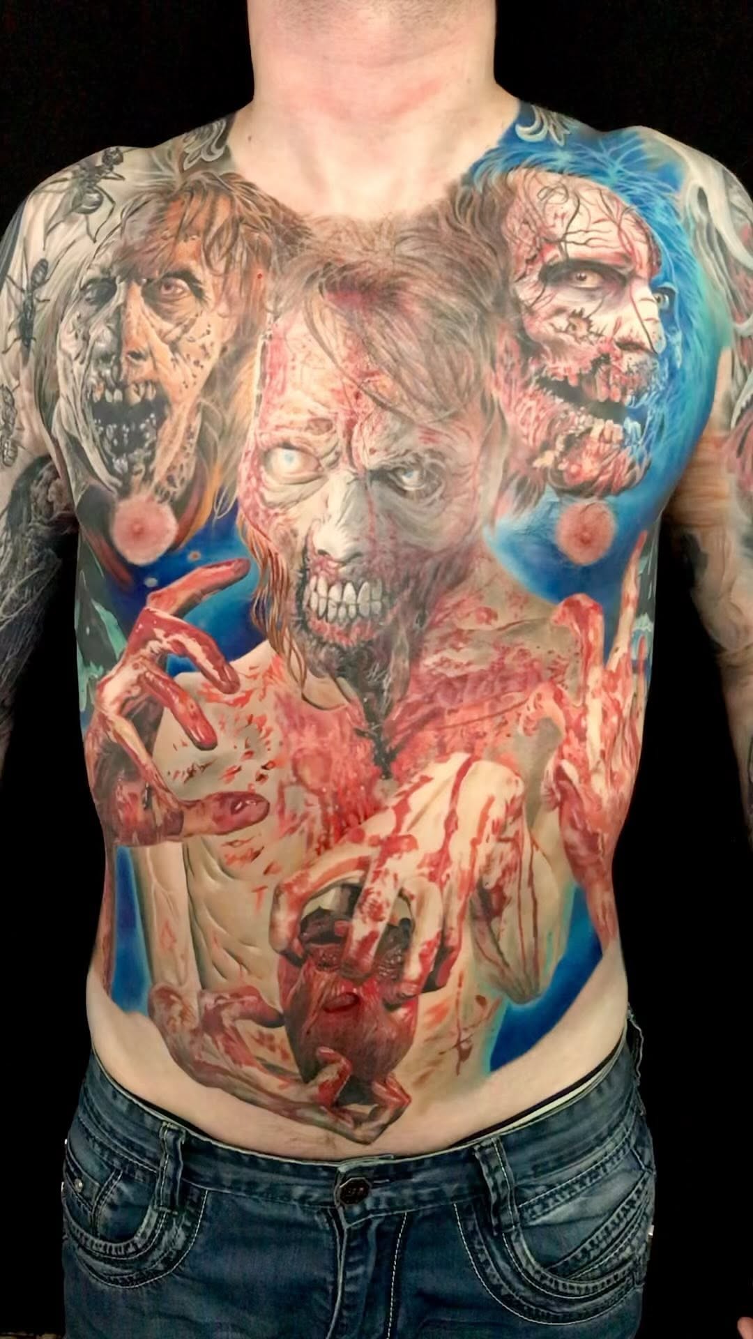 Blood-soaked zombie collage sprawled across chest and abs.
