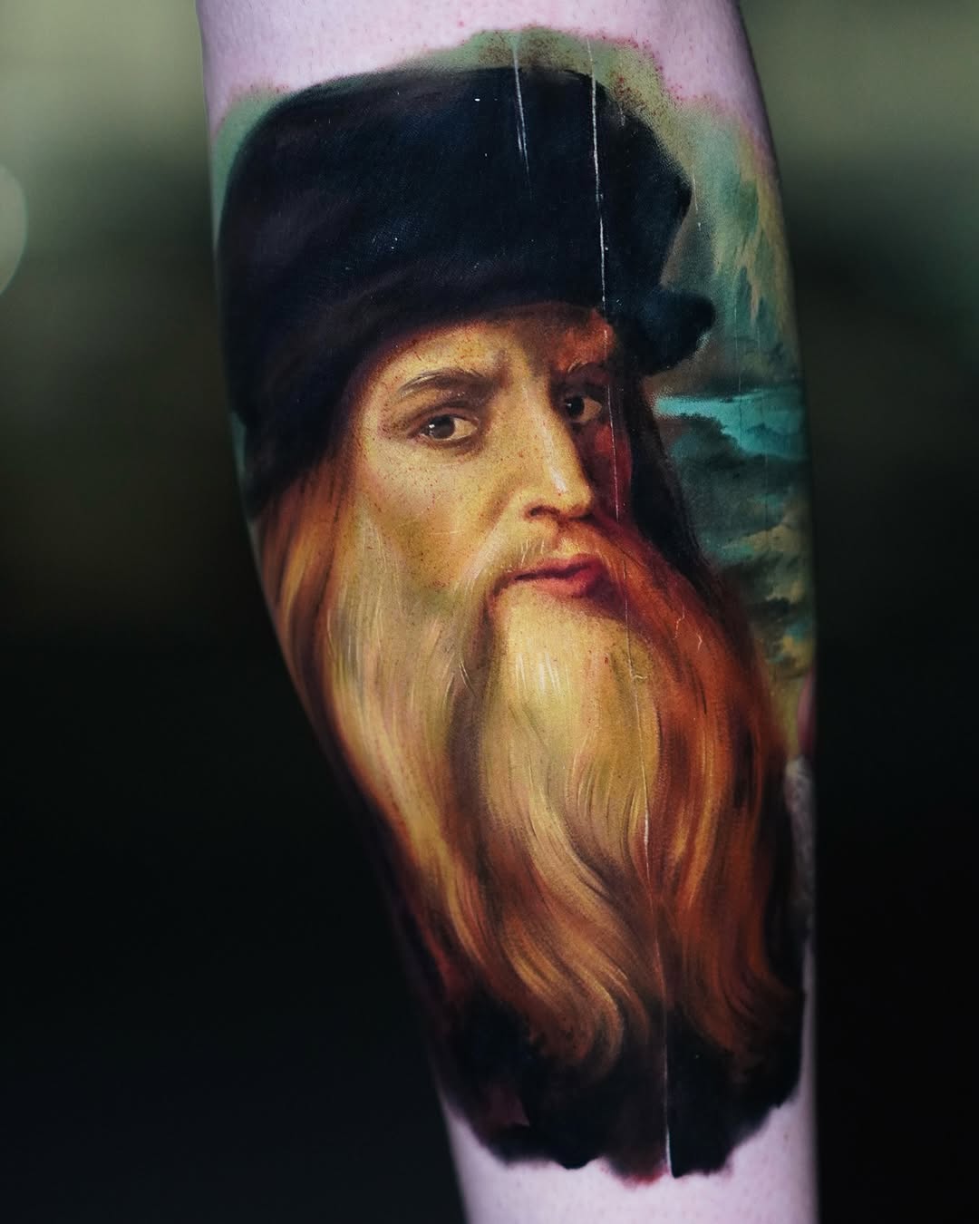 Realistic color portrait tattoo of an elderly, bearded man
