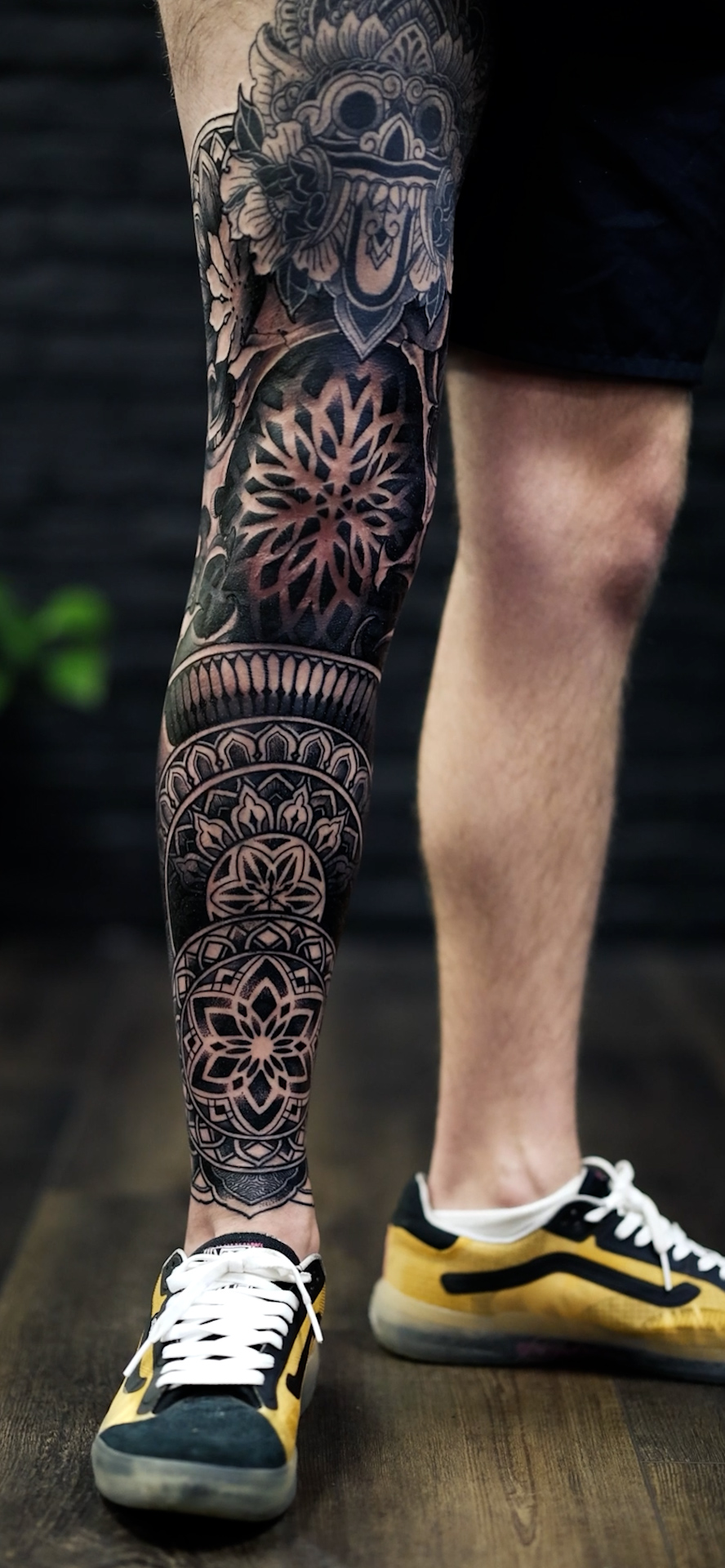 Intricate black-gray mandala sleeve with floral motifs