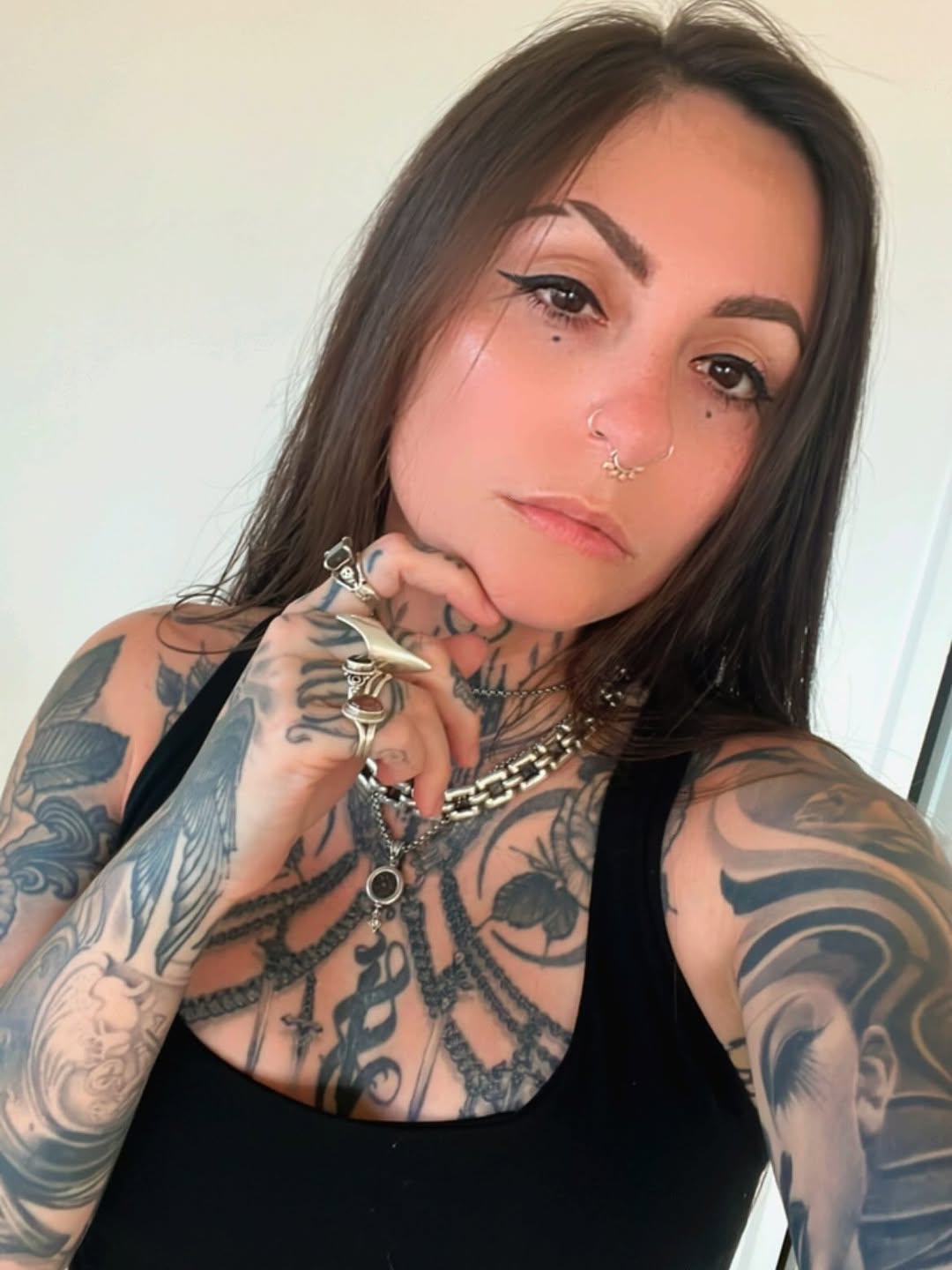 Bold blackwork with intricate floral patterns across chest and arms.